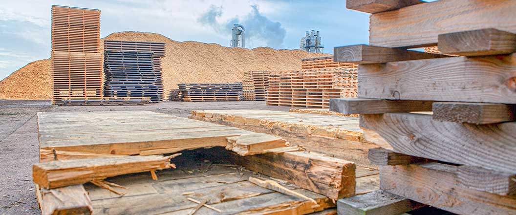 Pre-recycled pallets and wood chippings on site at a mill