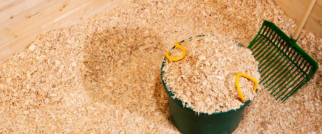 A bucket of wood chippings made from recycled pallets