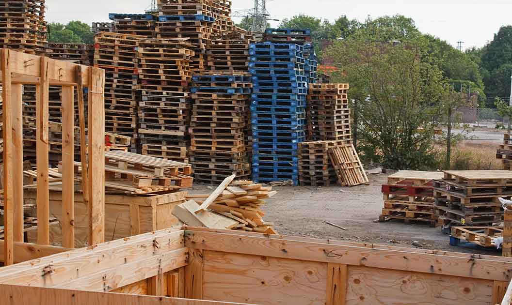 Stacks of brown and blue pallets to be recycled